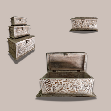 Set of wooden treasure chests with intricate carvings on a beige background