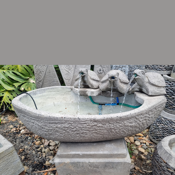 water fountain with three龙头 in a garden setting