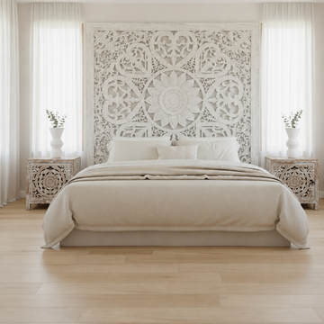 Coastal bedroom styled with a large white Balinese wall panel, hand-carved reclaimed teak bedside tables with whitewash finish, and white sculptural vases with dried eucalyptus stems — Azure Decor Australia