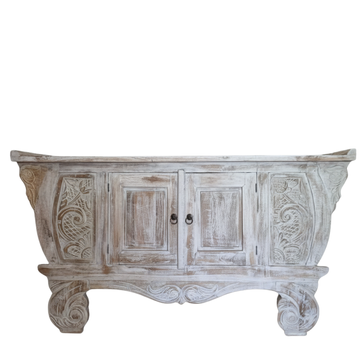 Hand-carved Balinese teak entryway cabinet whitewash finish, ornate carved legs and floral scrollwork on white background

