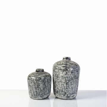 Terracotta bud vase in black wash rustic finish with brushed grey and white distressed texture on a grey background