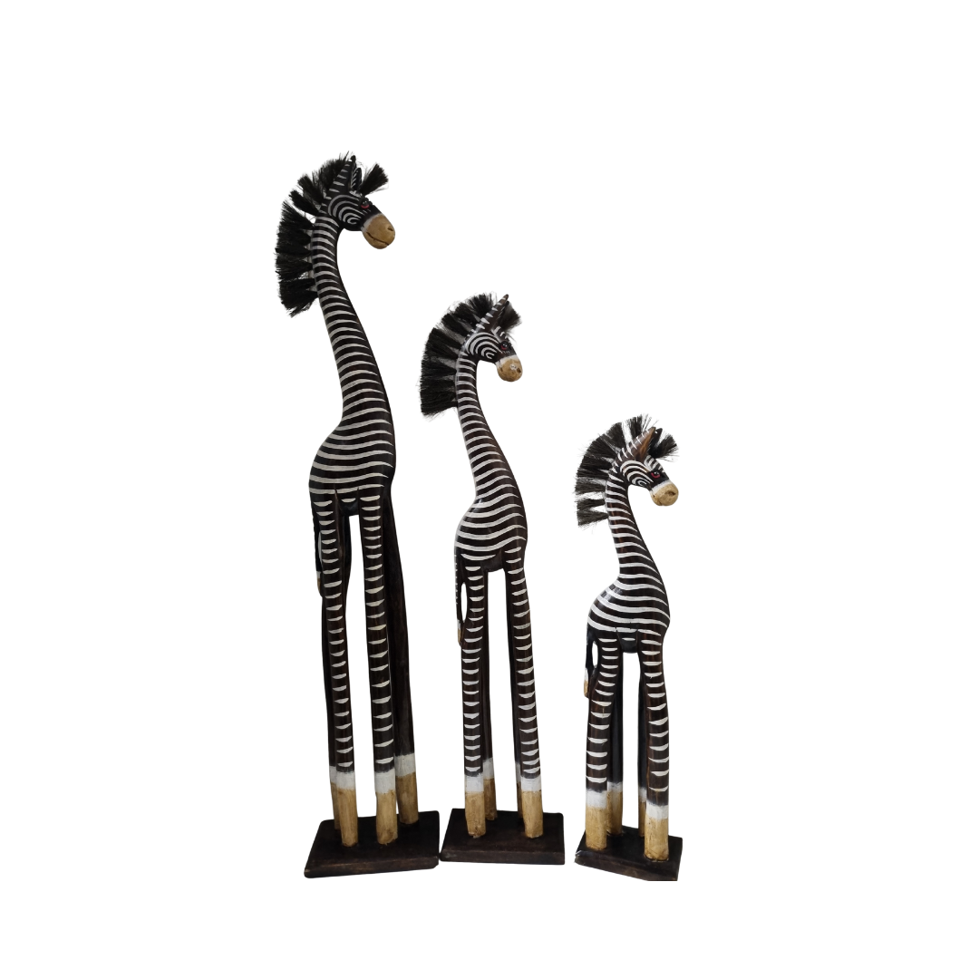 Three zebra figurines of different heights on a white background