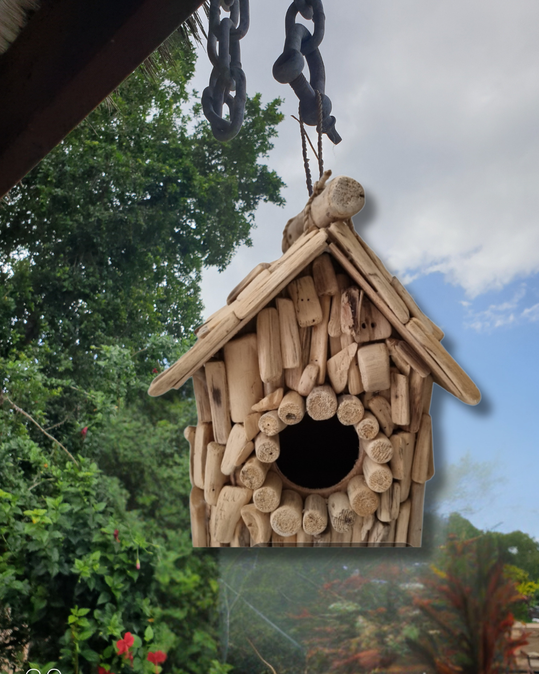 Wooden birdhouse hanging outdoors with a natural background