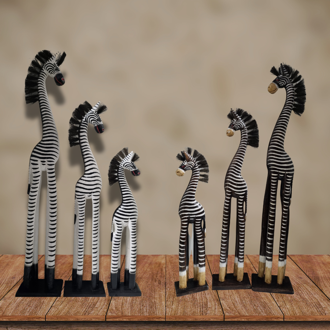 Set of six zebra figurines on a wooden surface with a beige background