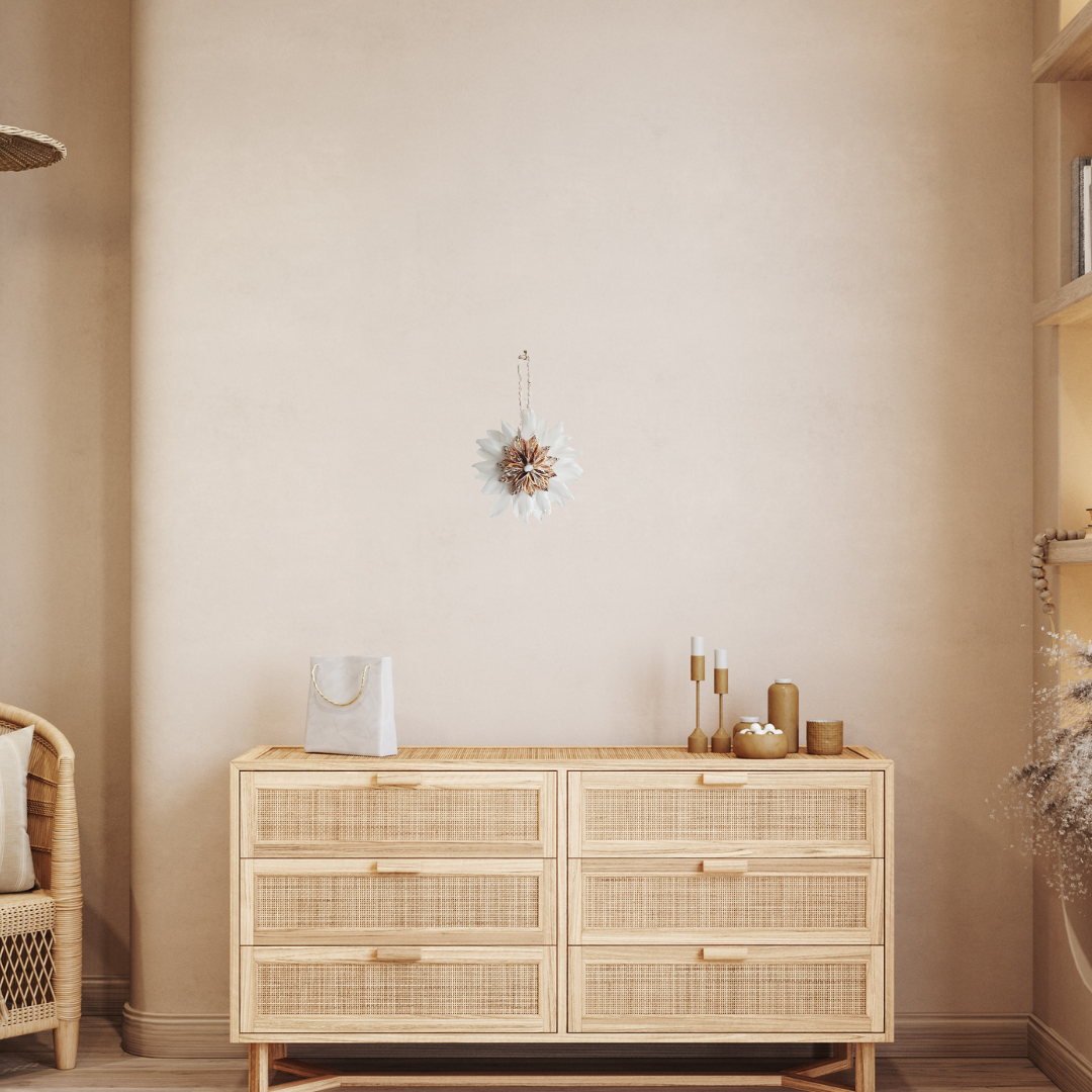Wicker sideboard against a beige wall with decorative items.