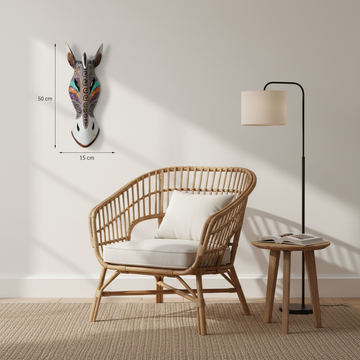 Colourful carved wooden zebra mask displayed beside a rattan chair in a relaxed reading corner