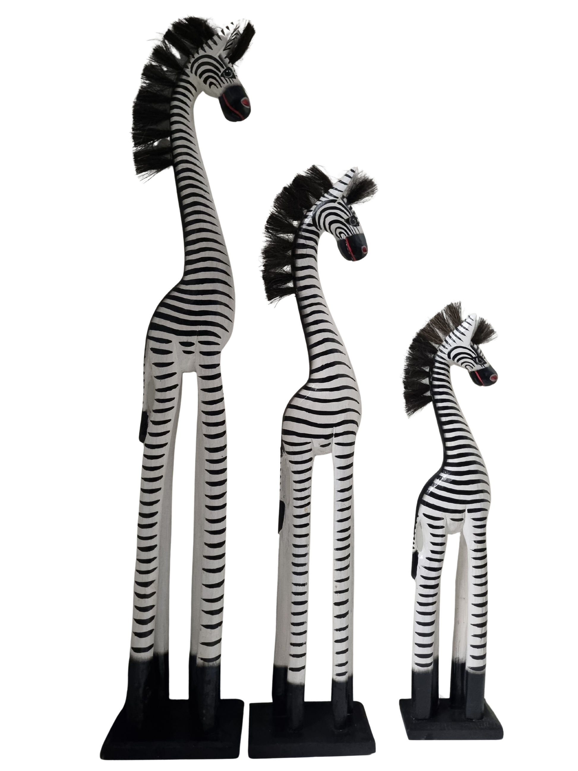 Three zebra figurines of different sizes on a white background