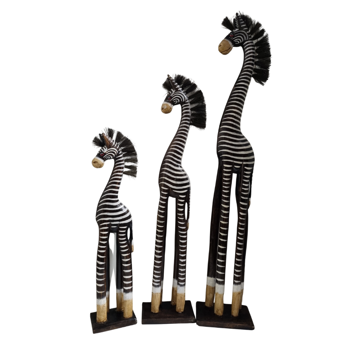 Three zebra figurines of different heights on a white background