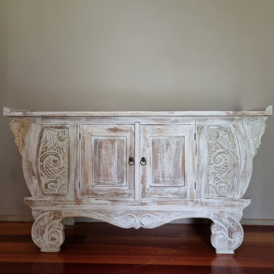 Whitewashed hand-carved Balinese teak entryway cabinet front view on timber floor, ornate scrollwork and ring door handles