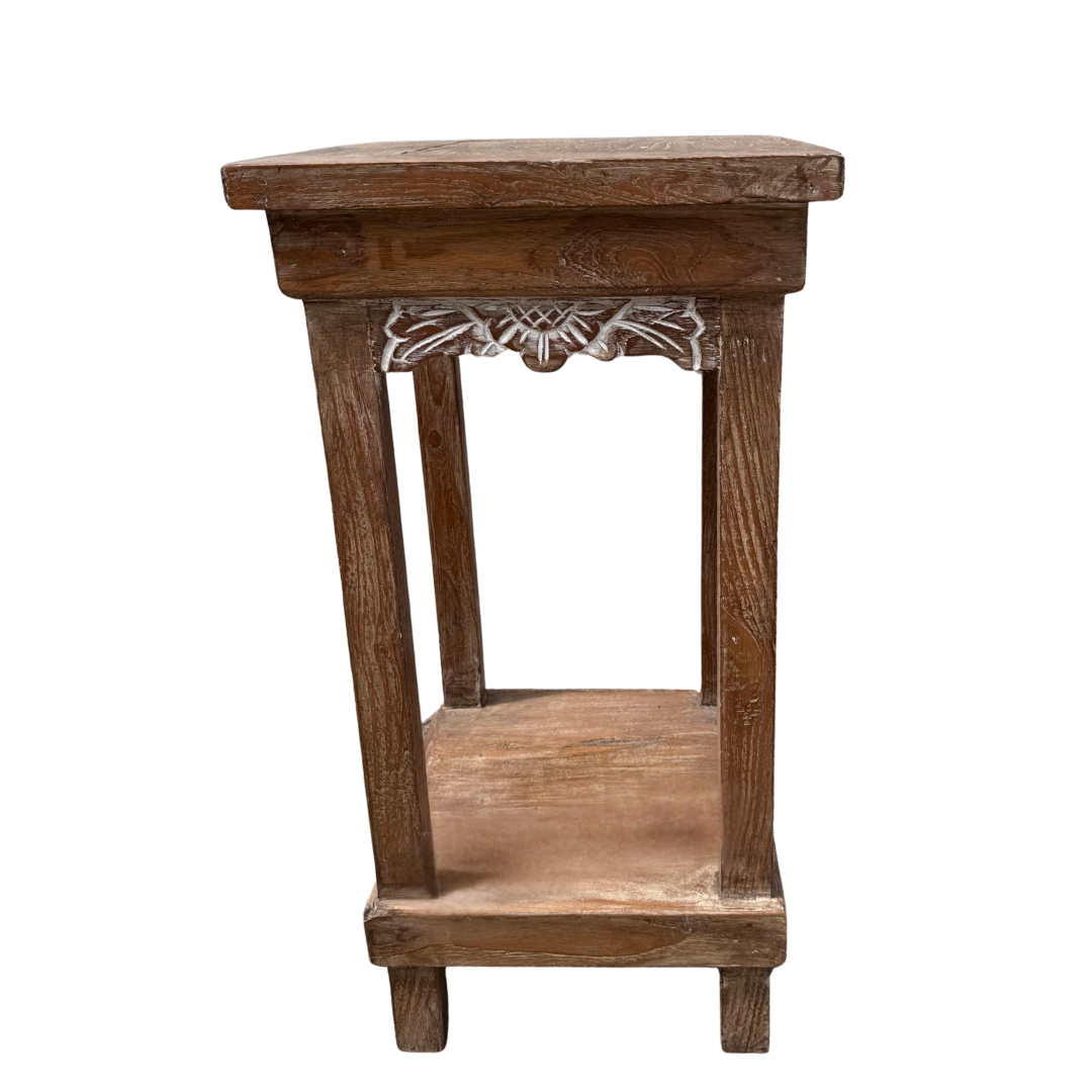 Wooden side table with decorative carvings on a white background