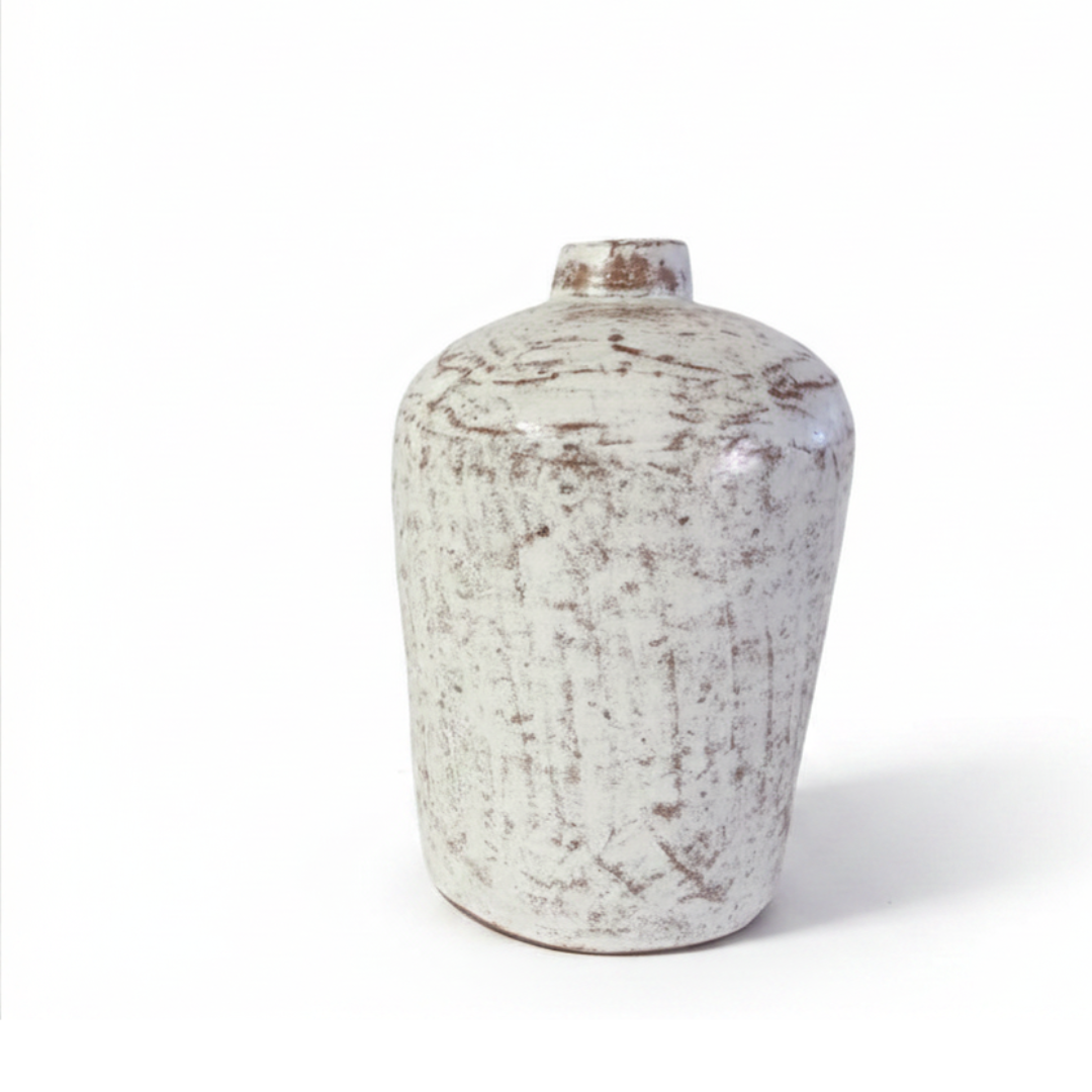 Tall white wash distressed terracotta vase with mottled rustic texture and narrow neck on a white background
