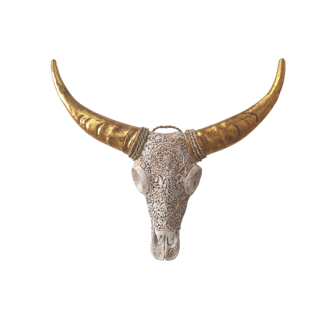 Decorative bull skull with gold horns on a white background