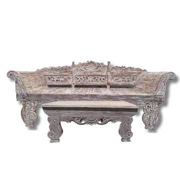 Carved wooden bench with intricate patterns on a white background