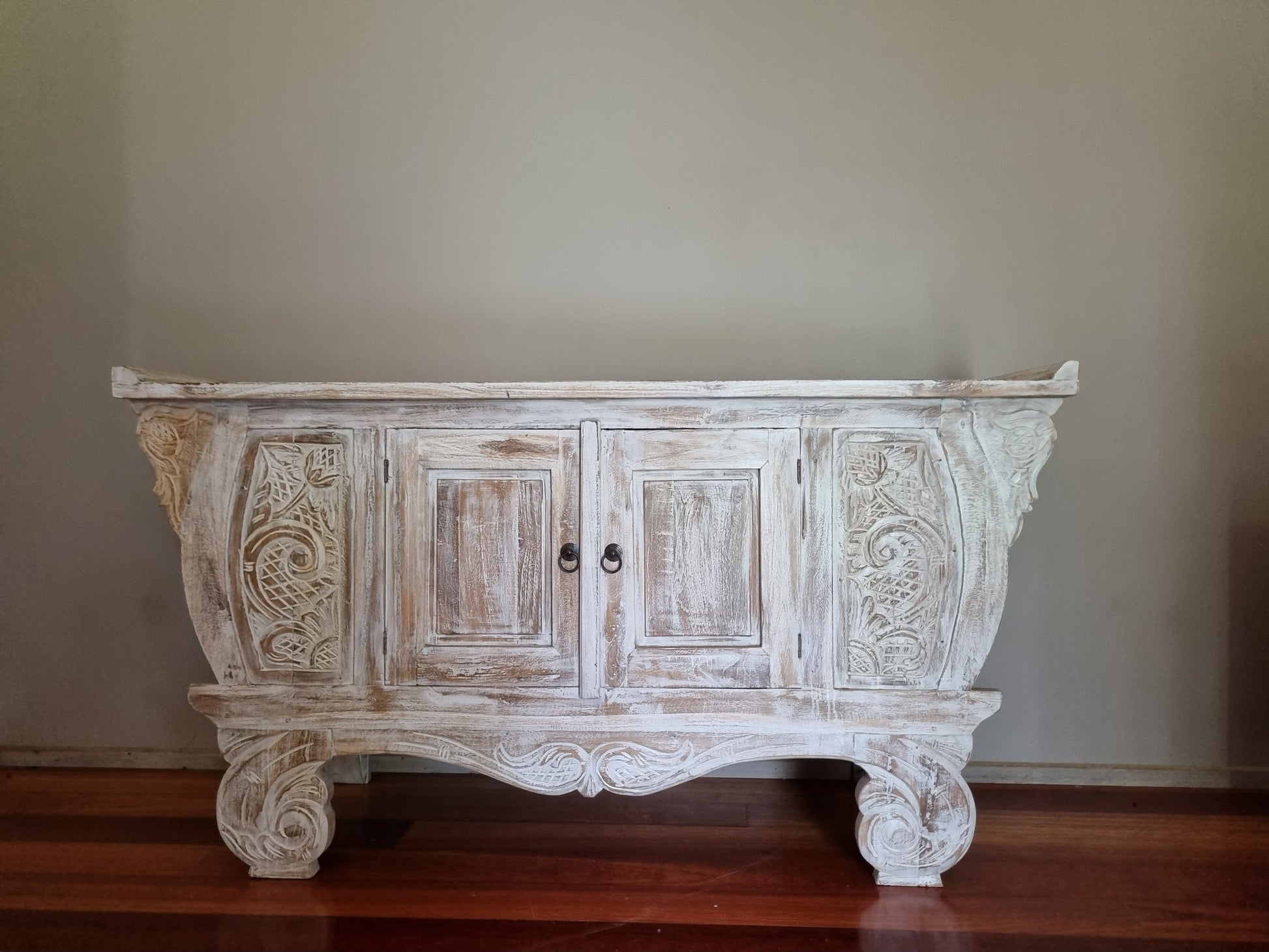 balinese style cabinet set in a neutral toned background 