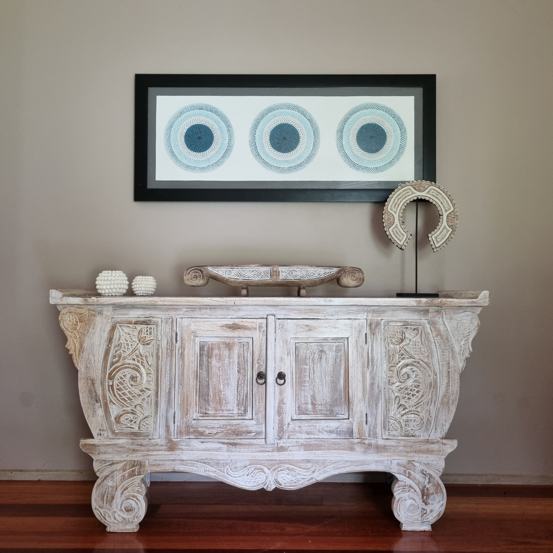 Balinese style art on back wall elegant wooden carved table with decor items