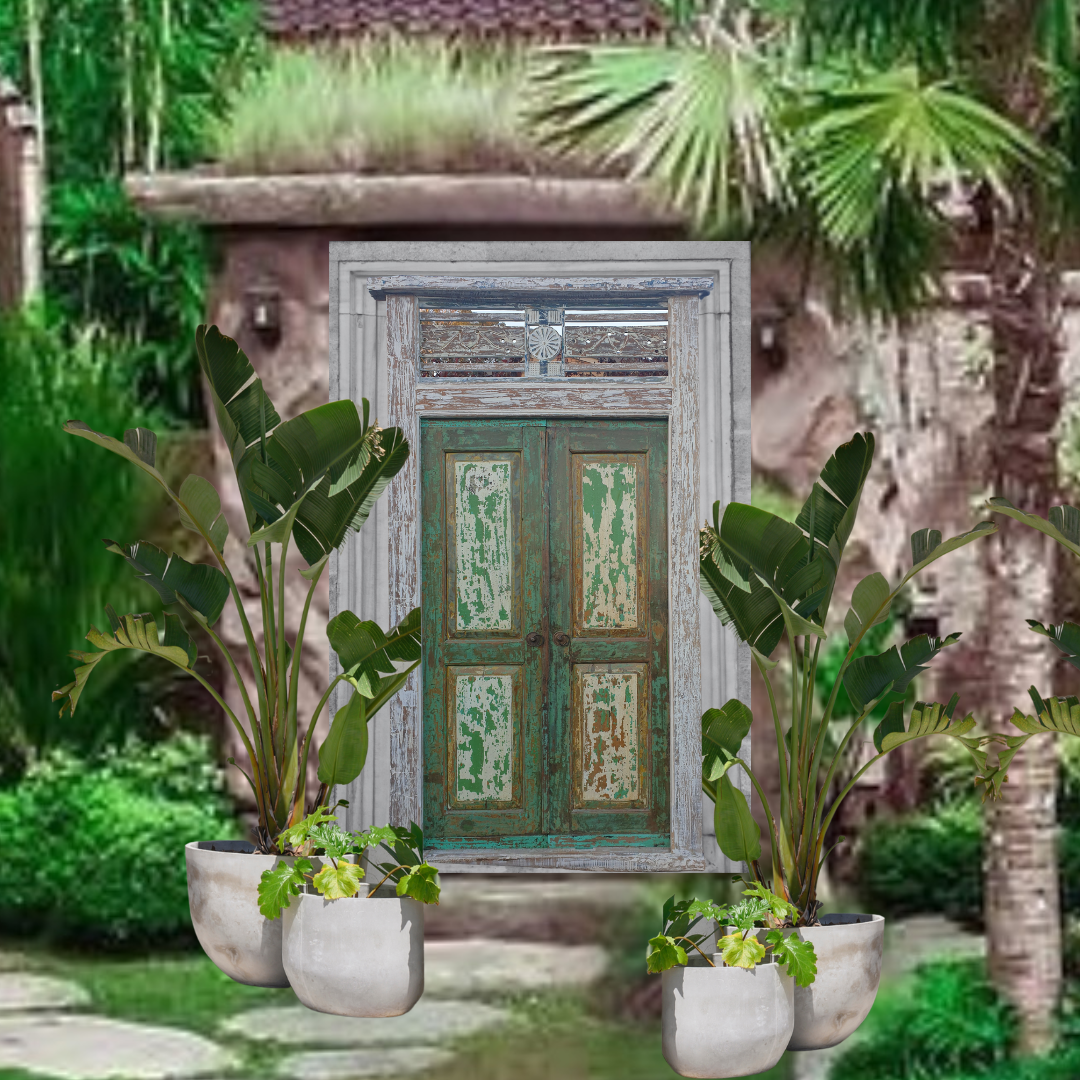 Decorative wooden door with potted plants in a garden setting