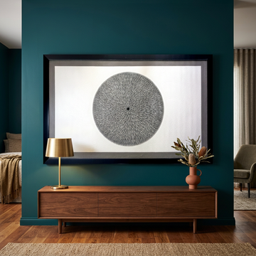 Balinese dot art painting on a deep teal wall above a walnut console, styled with a brass lamp and terracotta vase.
