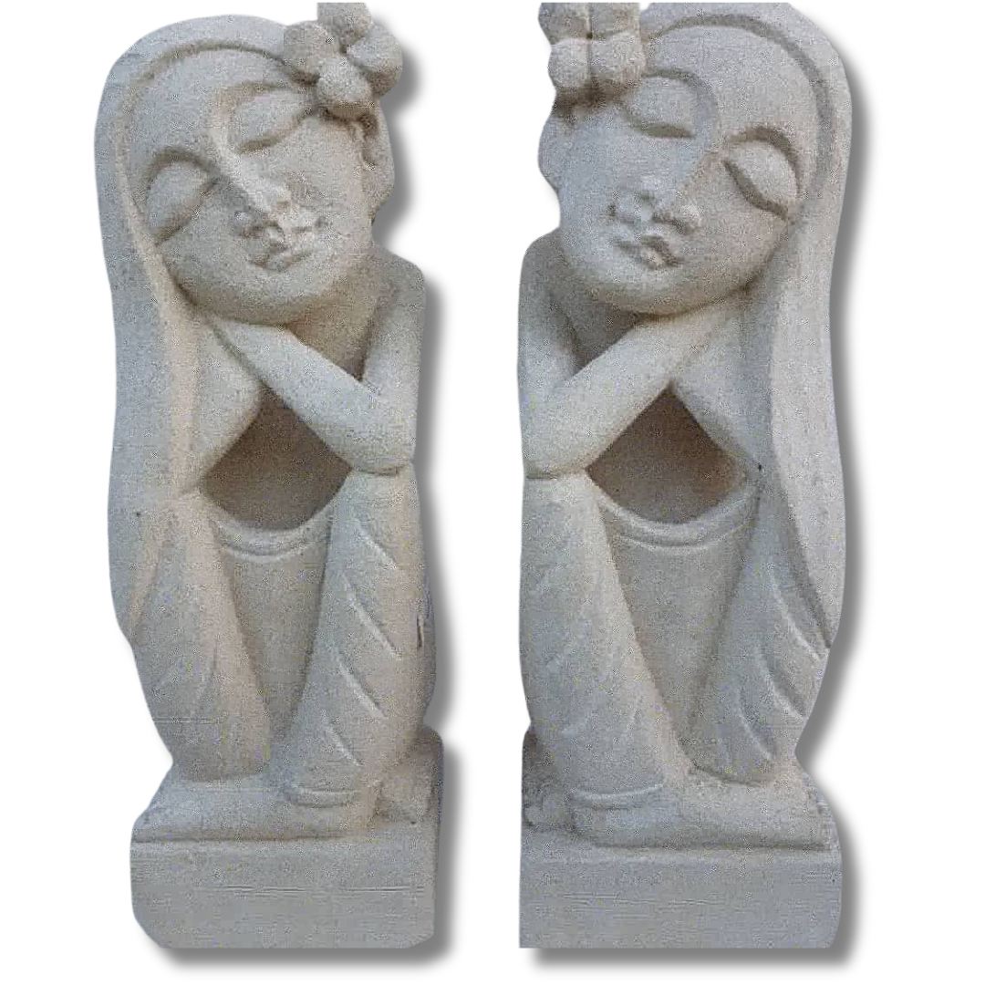 Two hand-carved limestone statues of a resting in tranquility couple in a resting pose, posed with hands resting on knees.