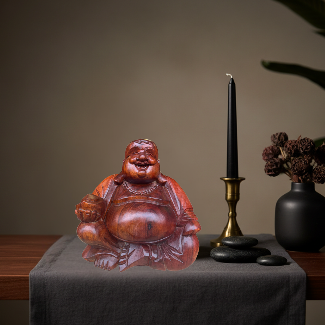 Reddish-brown carved wooden figurine styled on a dark timber table with charcoal linen runner, brass taper candle, black river stones and dried botanicals in a warm moody interior