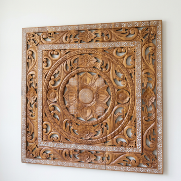 Balinese Lotus Mandella Carved Wall Art Angled view of the ornate timber piece on a white wall, showing a visible split through the lower section and border.