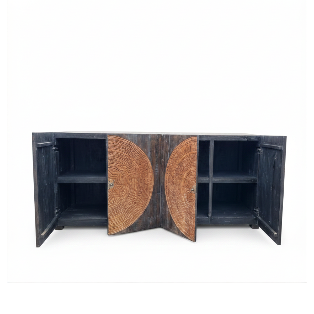 Black teak sideboard with four doors open revealing internal shelves and warm carved detail on open doors, white background