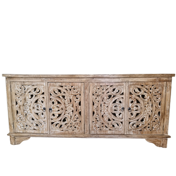 Hand-carved teak console cabinet with floral scroll doors styled with rattan mirror and coastal decor by Azure Decor