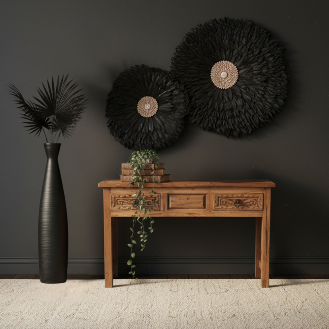Balinese teak console table styled in a moody dark interior with Mila matte black floor vase, dried fan palms, black juju hat wall art, trailing greenery, and brass singing bowl