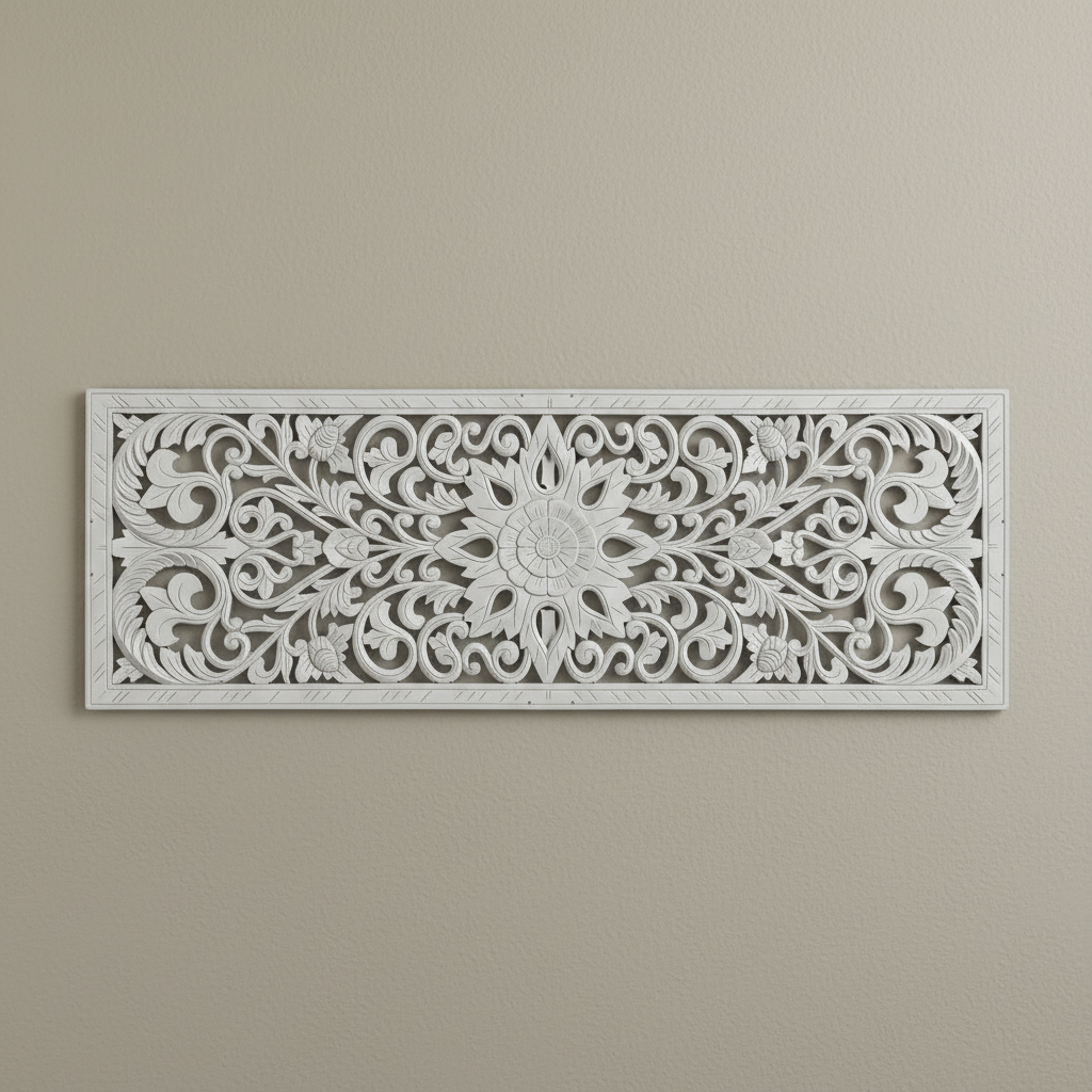 Ornate white carved panel photographed horizontally against a plain background