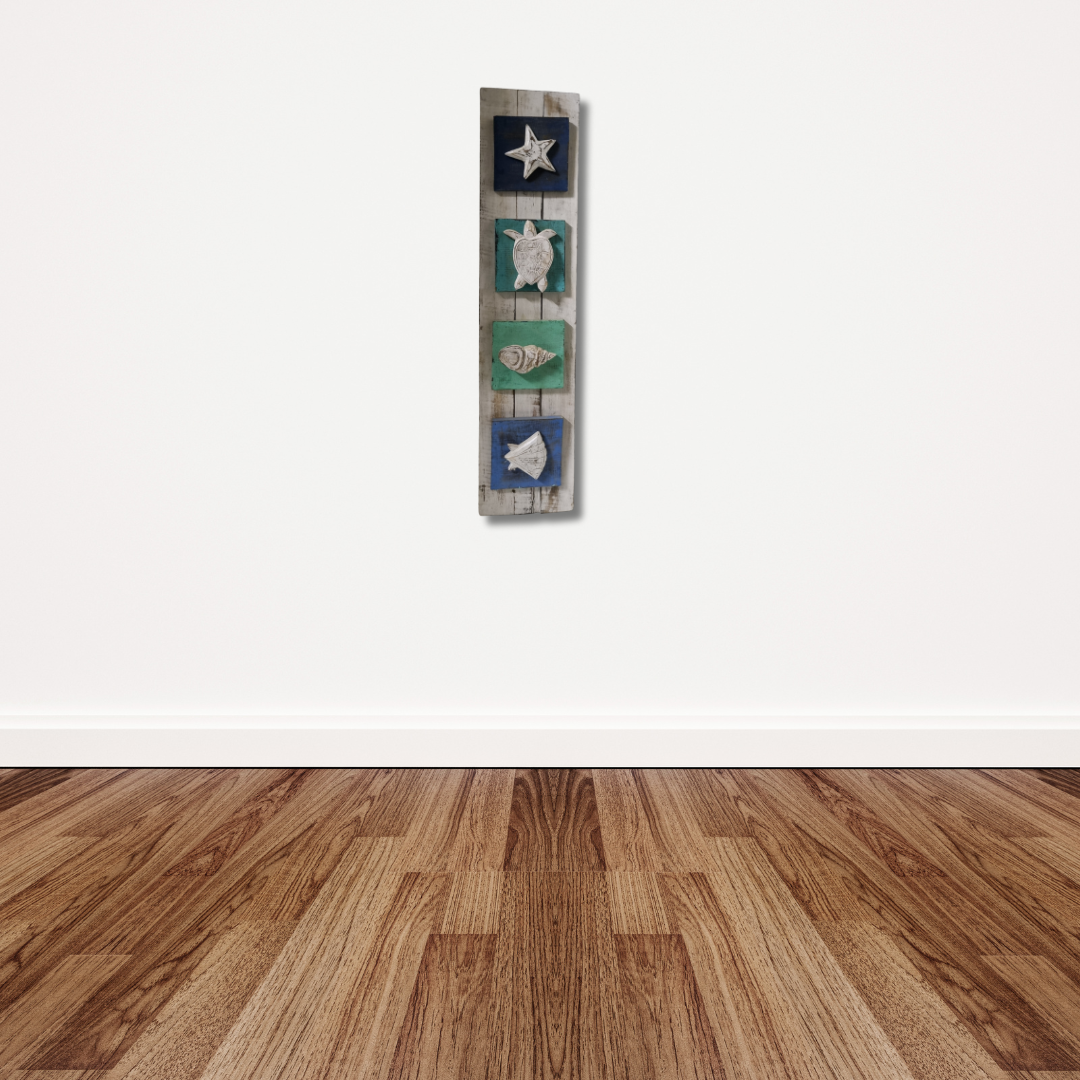 wooden wall art hanging in rustic white wash tones with carved sea animals on a living room wall 