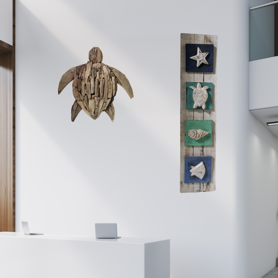 Wooden turtle sculpture and vertical wall art with sea-themed designs on a white wall.
