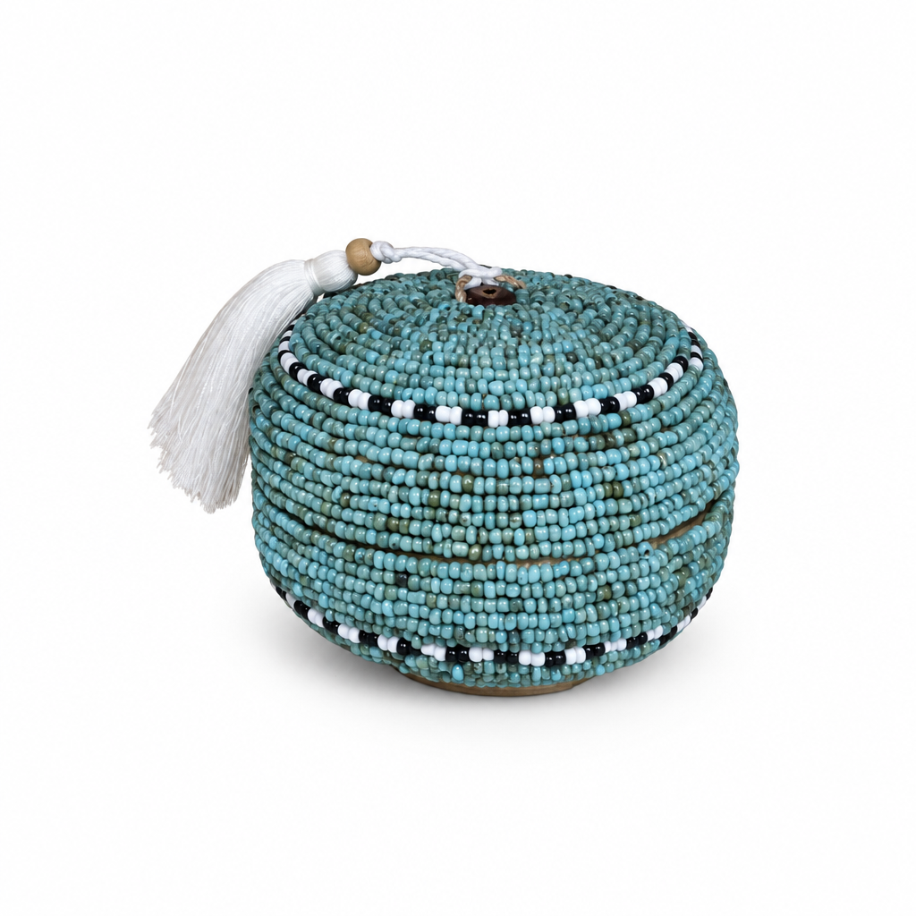 Teal-blue round beaded trinket box on a white background