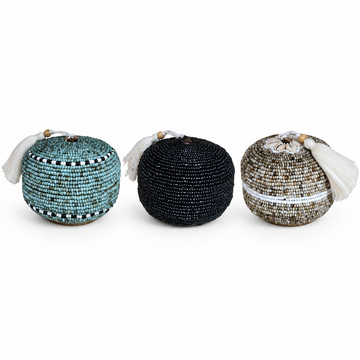  Teal-blue, black, and beige-brown beaded trinket boxes together on a white background