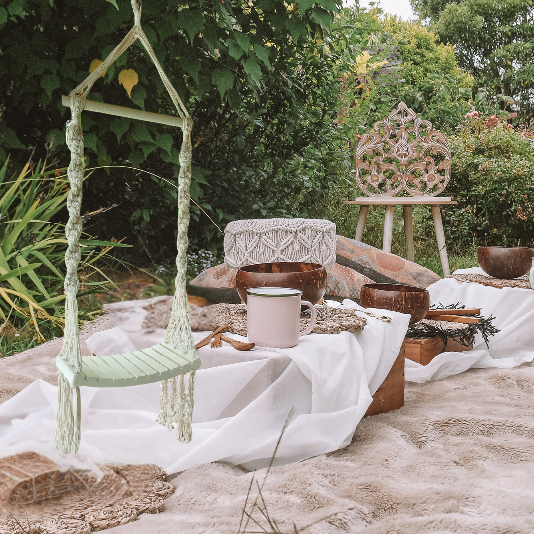 Boho_Bliss_Macrame_Swing.in an outdoor garden setting picnic setup 