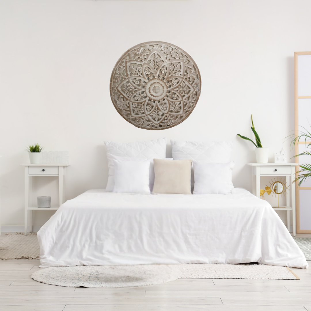 Neatly made bed with decorative wall art above it in a bright bedroom.