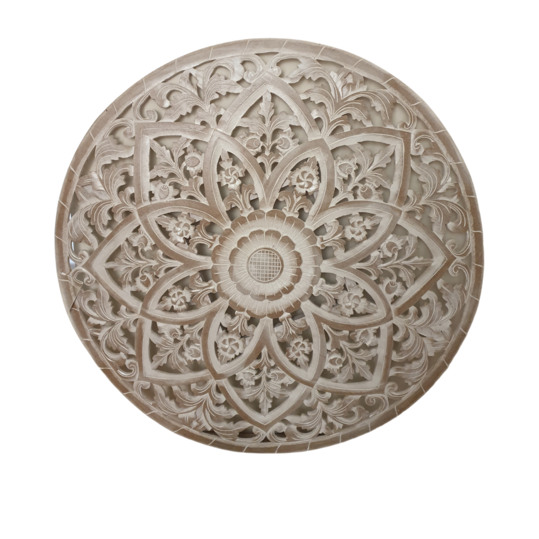 Decorative stone medallion with intricate carvings on a white background