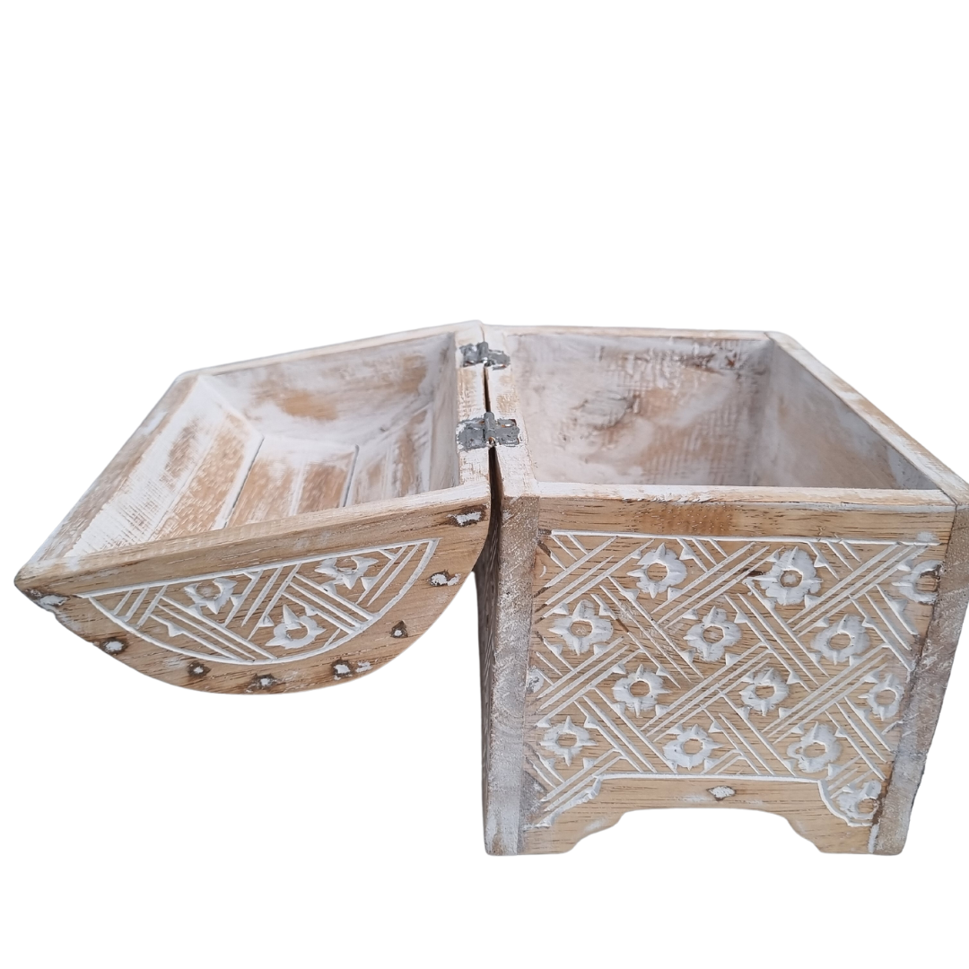 White wash carved wooden chest with lid open showing the raw timber interior and metal hinge, Balinese floral carvings on the exterior, white background