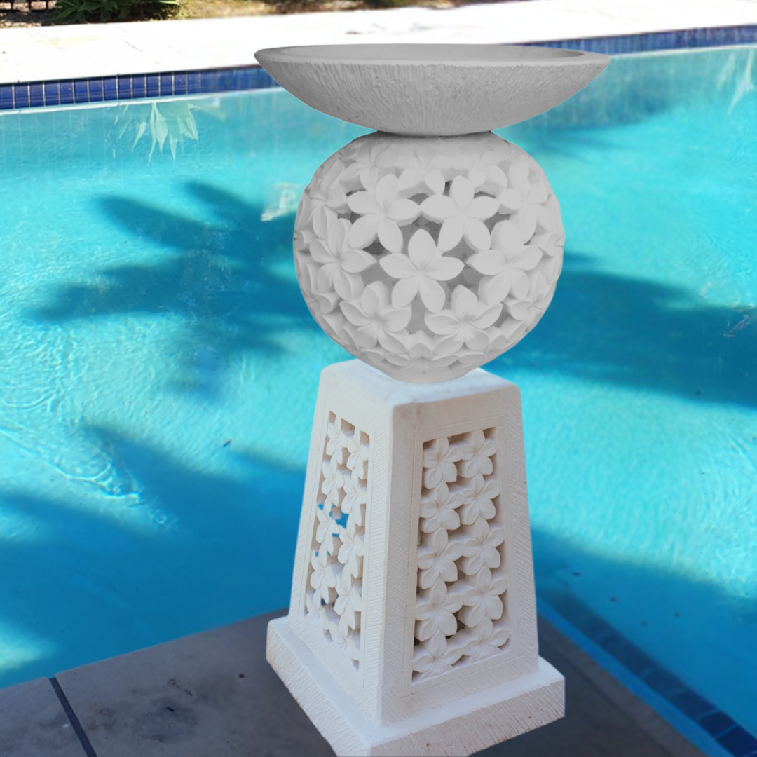 Planter-birdbath on stand in a poolside garden 