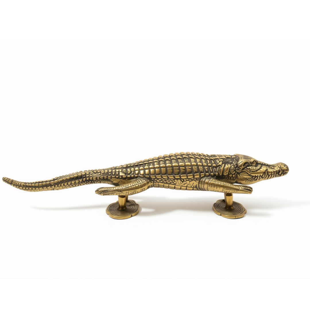 A brass-finished metal alligator figurine displayed on a clean white background.