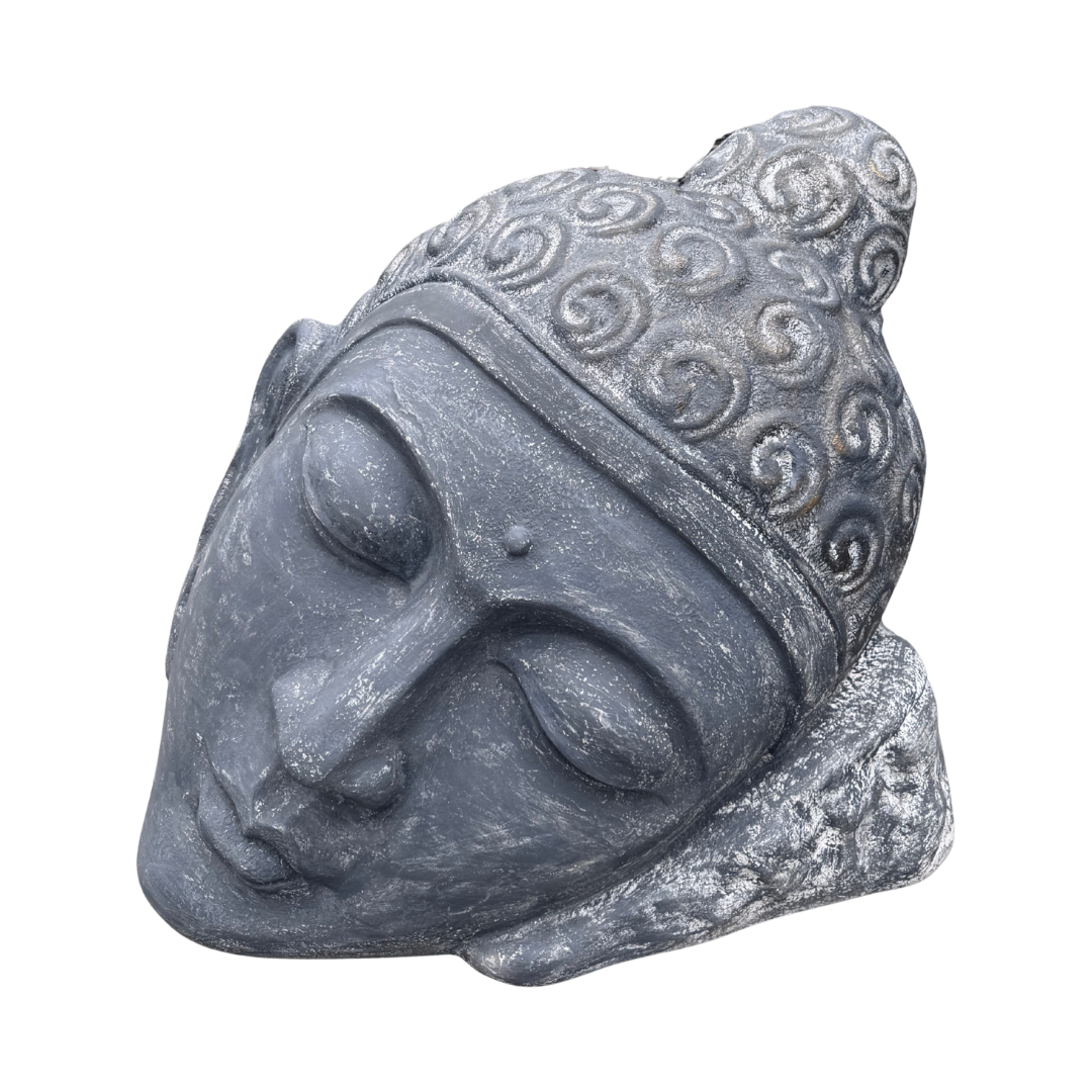 Decorative stone head sculpture with intricate patterns on a white background