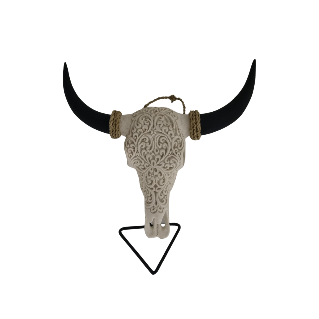 Ebony Elegance Skull – hand-painted resin bull skull with raised cream white floral scroll pattern and jute rope horn accents on black metal triangle stand, white background