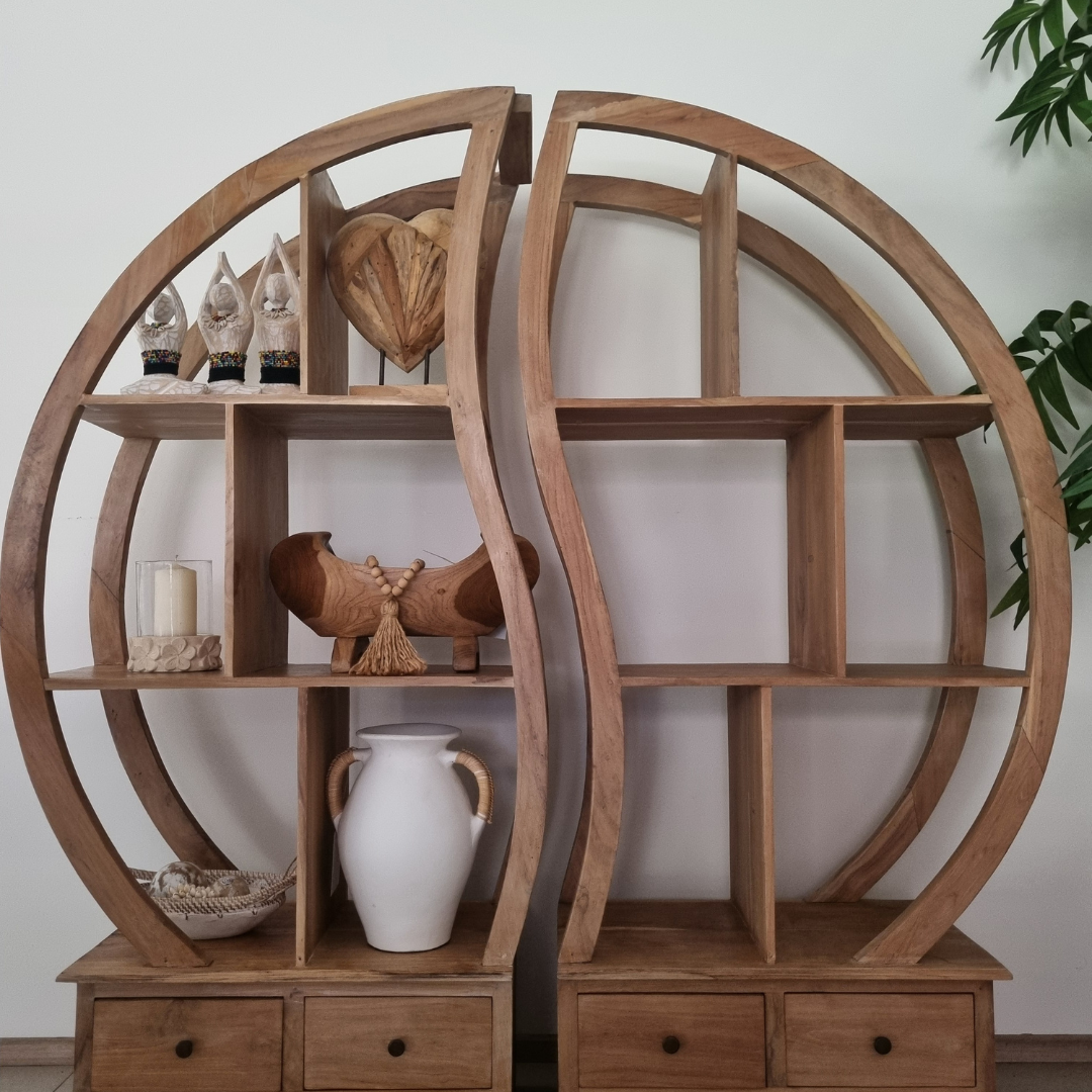 Wooden circular shelves with decorative items against a white wall.