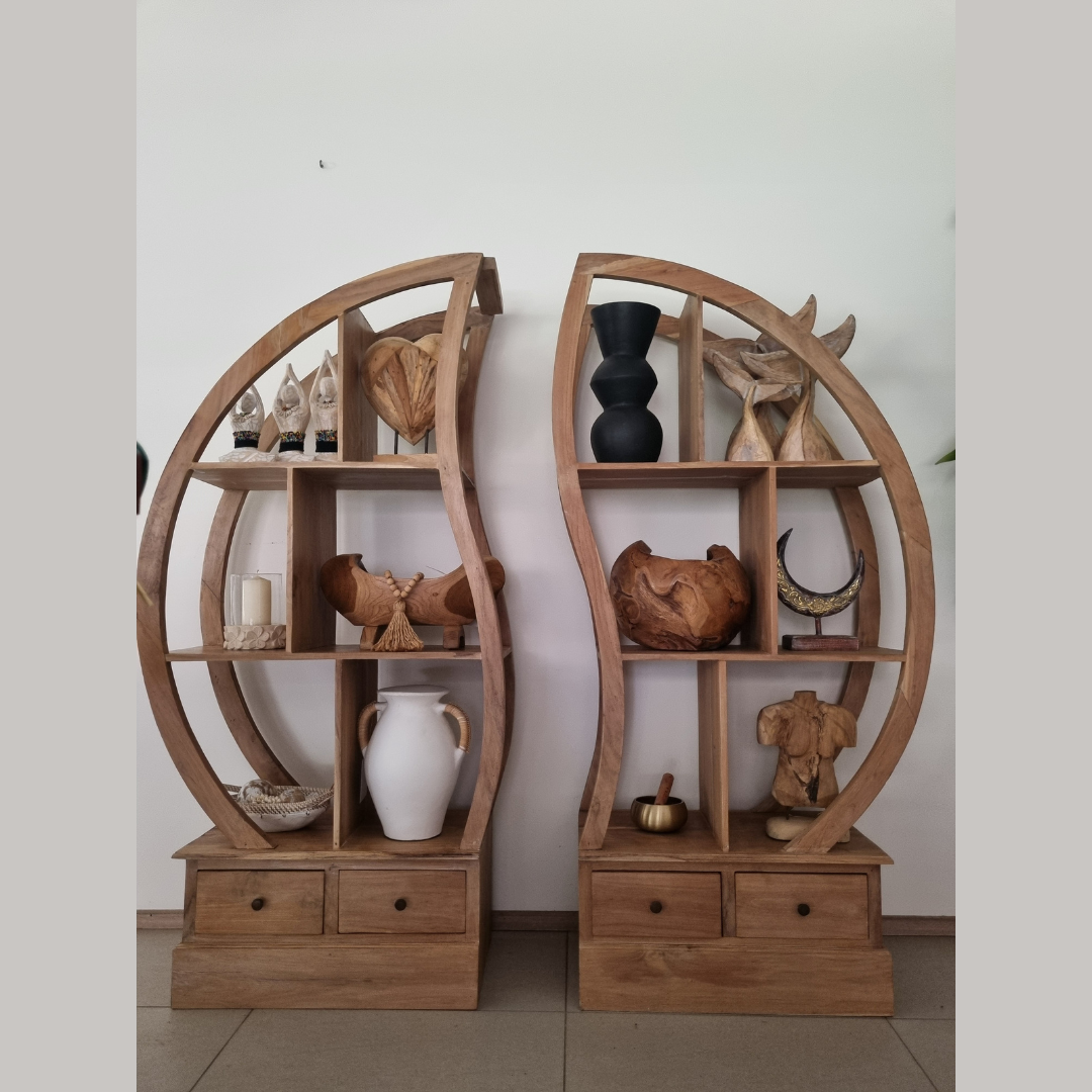Two wooden circular shelves with decorative items against a plain wall.