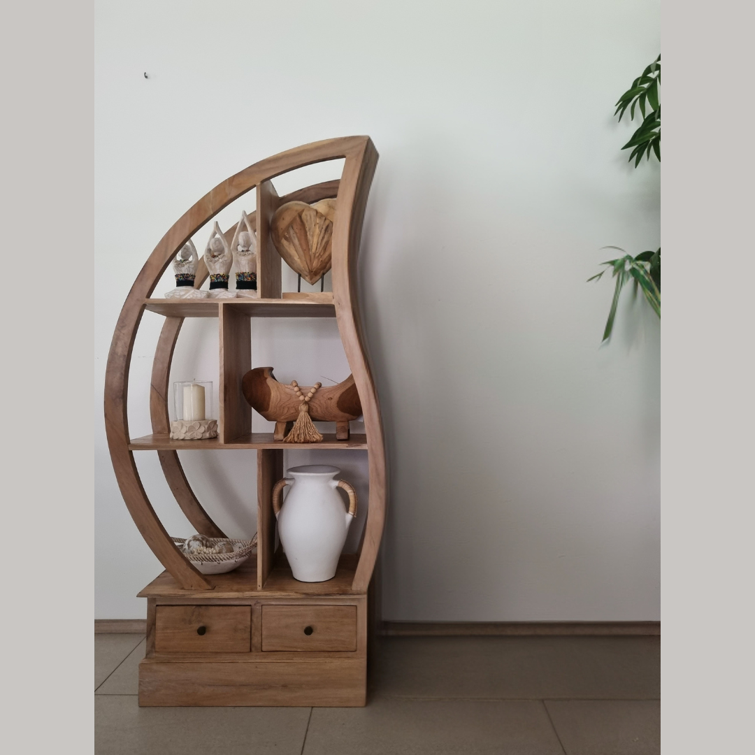 Wooden circular shelf with decorative items against a plain wall