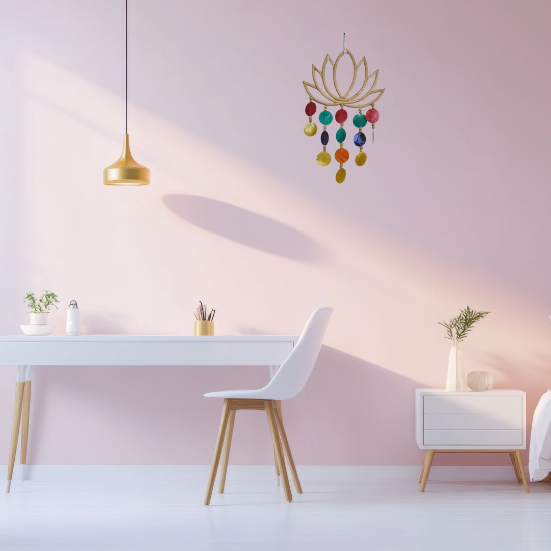 Modern interior with a pink wall, white table, and colorful chandelier.