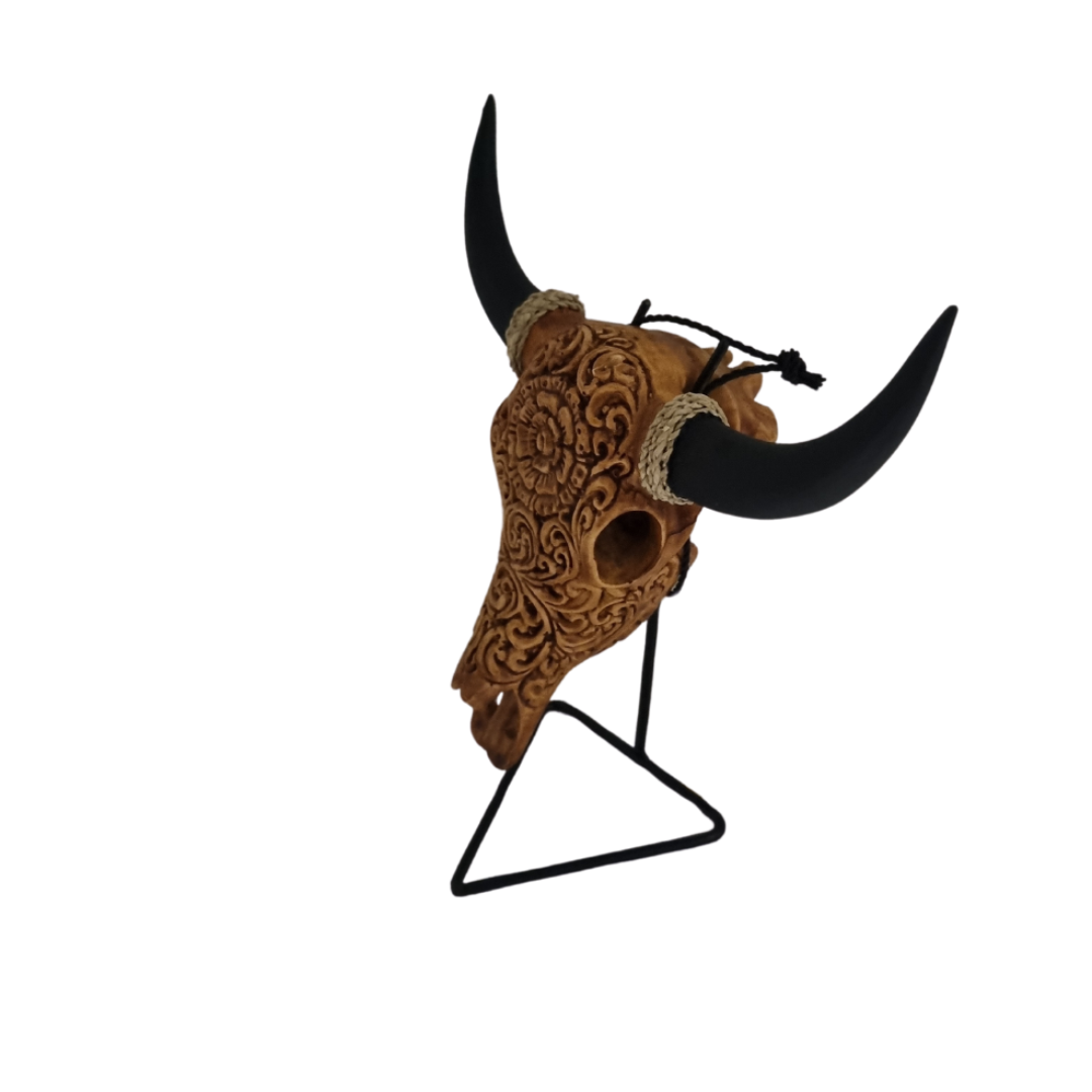 Celestial Flora Skull – hand-painted resin bull skull with intricate warm brown floral scroll pattern on black metal triangle stand, white background