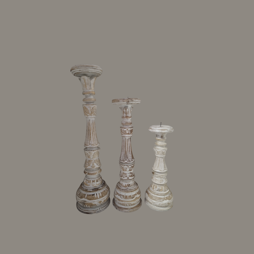 Three decorative candlesticks on a gray background