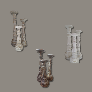 Set of decorative candle holders on a gray background