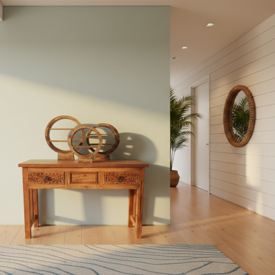 Brown wash circular wooden display stands set of three styled on a carved timber console table in a coastal Hamptons hallway with rattan mirror and palm plant