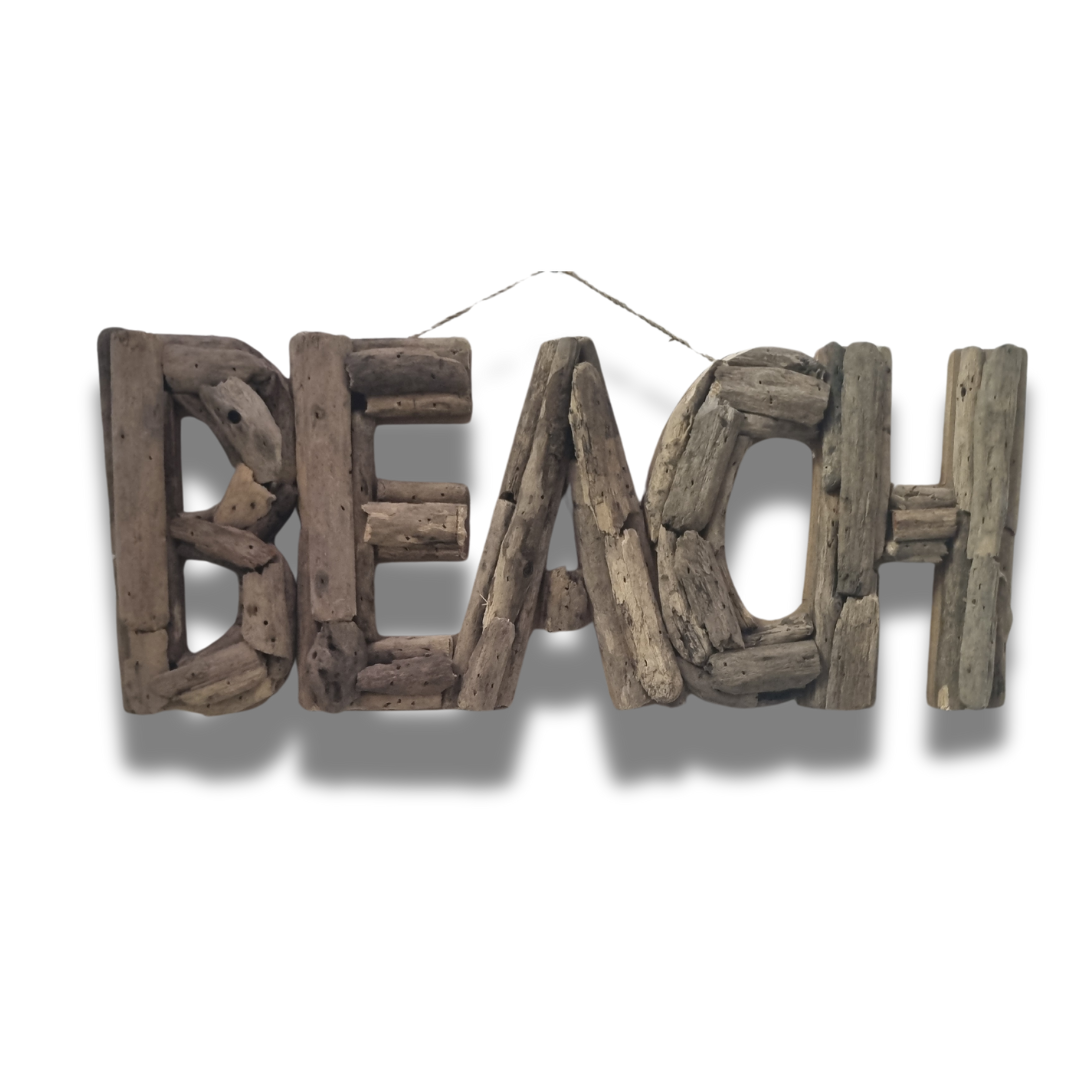 Decorative sign with 'BEACH' made from wooden driftwood pieces on a white background