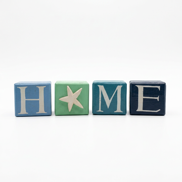White background, blocks separated
“Four individual painted squares spaced apart on white, featuring cream H, M and E letters and a raised starfish